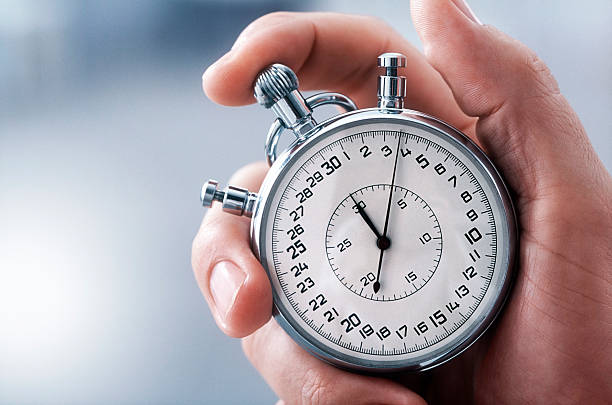 Hand holding stopwatch showing speed and quick execution