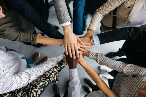 Team hands coming together in collaboration, representing streamlined marketing operations