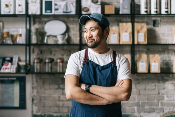 Small business owner in apron standing confidently in his shop, representing the entrepreneurs Lofi empowers