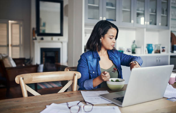Woman working efficiently at home with laptop
